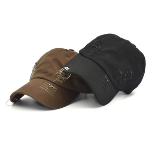 Close-up of distressed cotton baseball cap with silver metal rings and frayed hole details