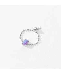 Detailed view of adjustable S925 silver ring with purple square opal on white background