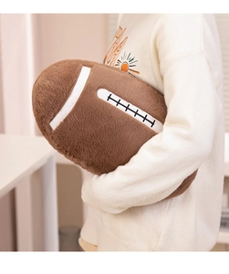 Detail of plush brown American football pillow with realistic white stitching texture