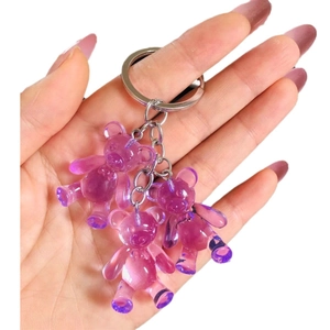 Cute purple jelly gummy bear keychains made of transparent resin held in hand