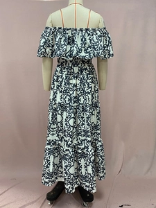 Detail of off-shoulder neckline and tiered ruffled layers of printed maxi dress