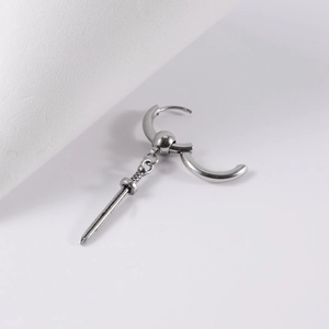 Detail of polished stainless steel sword pendant hoop earring with fine texture design