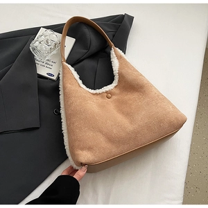 Detail of camel suede tote bag with white faux fur trim and brown leather handles