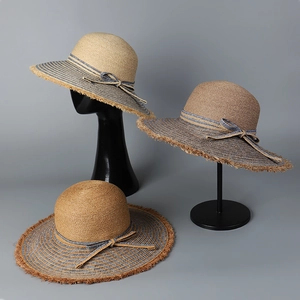 Women's wide brim straw sun hat with denim ribbon bow and frayed edges for summer boho style