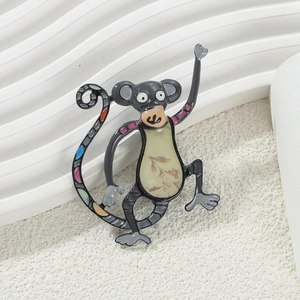 Close-up of a colorful monkey enamel brooch with intricate patterns and vibrant metal finish