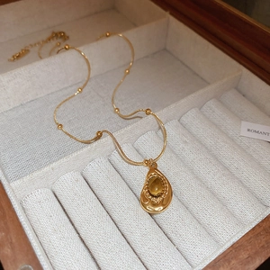 French vintage gold necklace featuring a teardrop tiger eye stone pendant on a beaded chain
