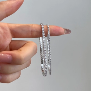 Close-up of double-loop 925 silver tennis bracelet with cubic zirconia on a hand