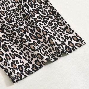 Close-up of leopard print fabric showing fine stitching and smooth weave texture