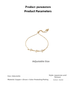 Close-up of adjustable gold bracelet with three fishtail charms and white cubic zirconia