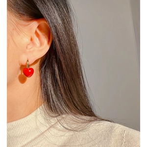 Handmade red enamel heart hoop earrings with gold metal hook in a stylish minimalist design
