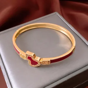 18k gold plated open bangle featuring a diamond-set gourd charm and red enamel inlay