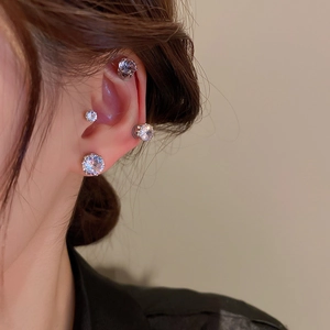 Magnetic zircon clip-on earrings in multiple sizes on model's ear for multi-piercing look