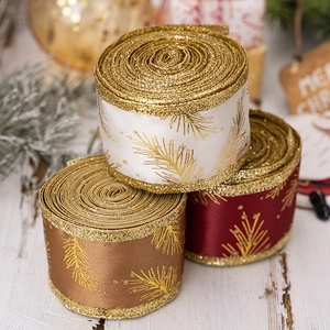 Close-up of glittery Christmas ribbons in white, gold, and burgundy with gold branch patterns
