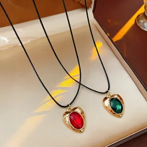 Vintage gold heart pendant necklace with red and green crystals on black cord chains