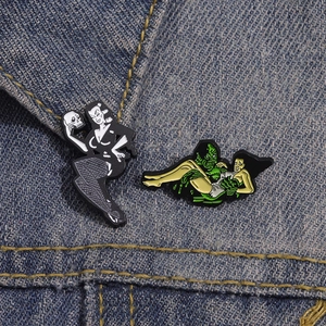 Gothic woman and retro movie monster enamel pins on a denim jacket collar