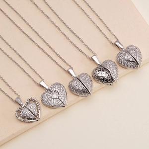 Elegant silver heart necklace set with zircon stones on a beige textured background