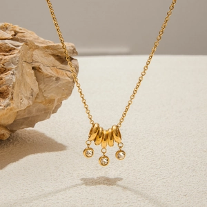 18K gold-plated stainless steel necklace featuring tiered metal rings and crystal charms