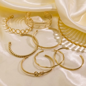 Luxurious 14K gold plated titanium steel open bangles with diverse geometric textures