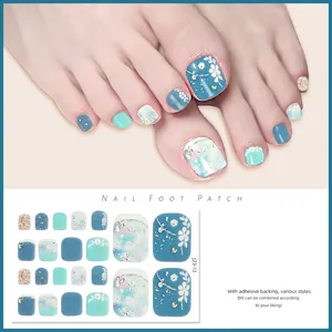 Detail of blue and silver glitter toenail stickers featuring floral and snowflake patterns