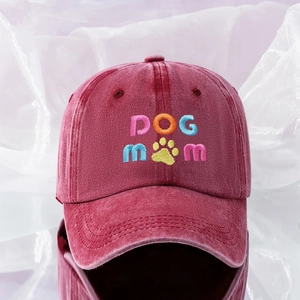 Close-up of colorful DOG MOM embroidery and paw print on washed dark red baseball cap