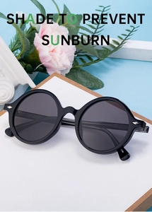 Chic round black frame sunglasses displayed with summer flowers and aesthetic props