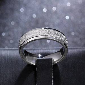 Detail view of 6mm titanium steel ring with matte sandblasted finish and polished silver edge