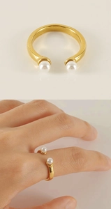 Close-up of a 18k gold-plated open ring featuring two elegant white pearls for women