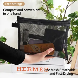 Handheld black mesh cosmetic bag with zipper for travel toiletries and stationery storage