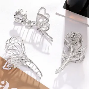 Macro detail of silver rose metal hair claws set with sparkling rhinestone accents