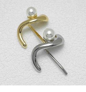 Detailed view of elegant gold and silver curved hair hooks with inlaid white pearls