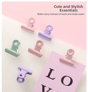 Macro shot of macaron colored metal binder clips in pink mint and lavender colors