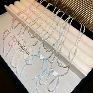 Colorful beaded bow necklaces with heart pendants and imitation pearls in soft pastel colors