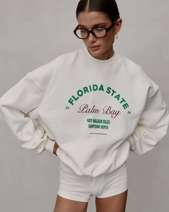 Close-up of retro Florida State letter print on oversized cream-colored crewneck sweatshirt