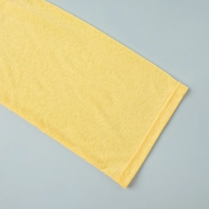 Detail of yellow beach set showing high-quality slub cotton texture and neat double stitching