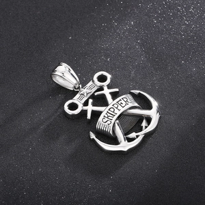 Detail of silver skull anchor and rudder pendant with Skipper banner engraving