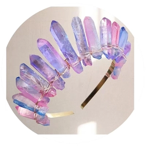 Close-up of handmade crown with raw pink and blue natural crystal pillars on metal headband
