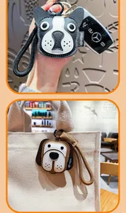 Detail of creative leather puppy keychain charms on a woven strap and canvas bag