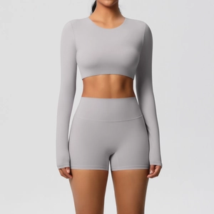 Front view of seamless grey yoga set with cropped long sleeve top and high waist shorts
