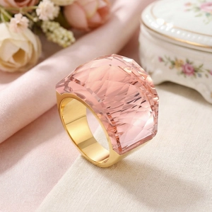 Detail of a large faceted pink crystal ring with a luxurious 18k gold-plated band
