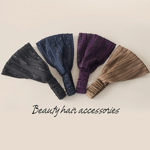 Detail of four knit elastic headbands in black, blue, purple, and brown with glitter yarn