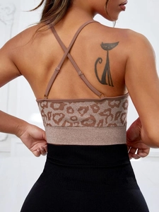 Close-up of leopard print sports bra with thin cross back straps and ribbed hem detail
