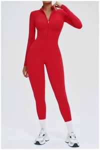 Macro shot of red long sleeve yoga jumpsuit featuring a half-zip neckline and seamless fabric