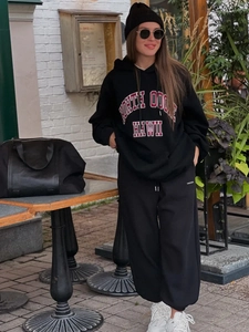 Detail of black cotton hoodie and joggers with North Hawaii varsity lettering print