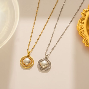 Detail of gold and silver square pearl necklaces with zircon accents on a tray