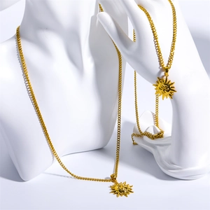 Detail of vintage sun face tarot necklace with gold plated cuban chain on a mannequin