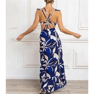 Detail of tropical leaf print maxi dress showing the open back crisscross straps and metal ring