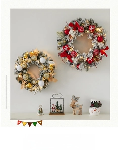 Detail of red and gold Christmas wreaths with warm LED lights and elegant bows