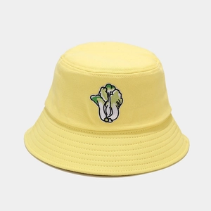 Detailed view of cabbage embroidery on yellow canvas bucket hat with reinforced brim