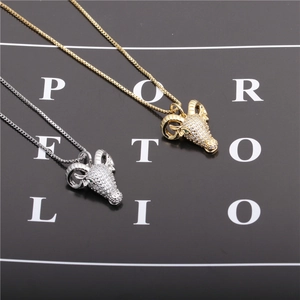 Gold and silver sheep head necklaces with clear stones and green eyes on box chains