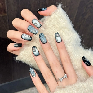 Winter dark blue snowflake press-on nails with cat eye effect and sparkling rhinestones